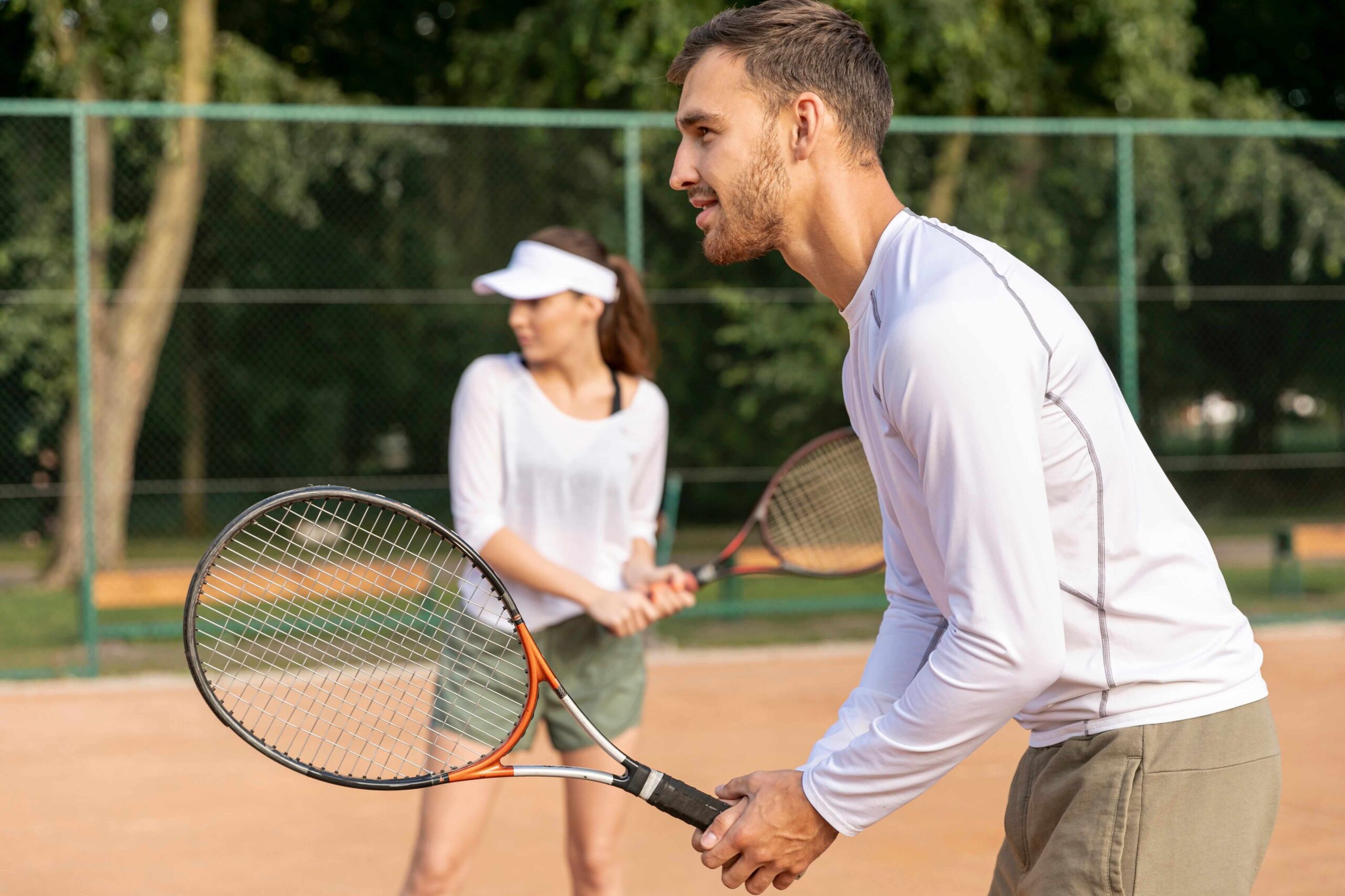 Active couple enjoying tennis